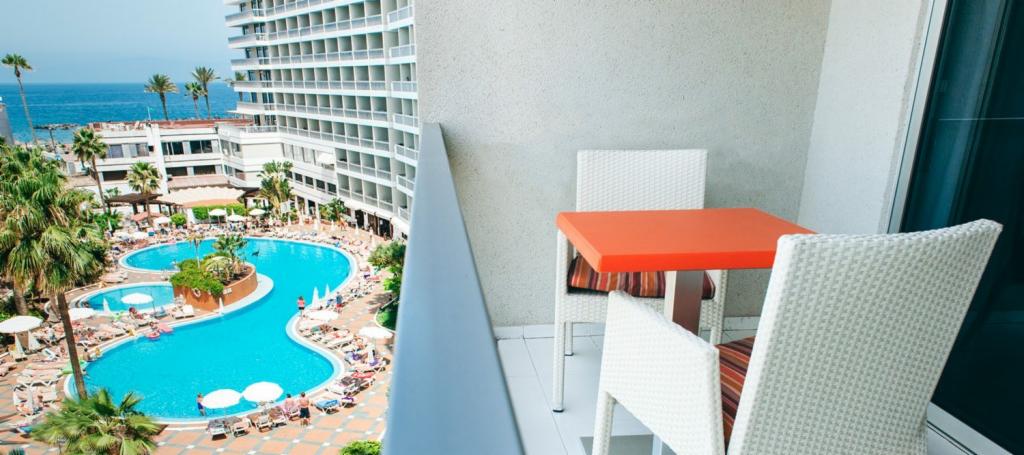 Balcony view of pool and sea in Palm Beach Club in Playa de las Americas, Tenerife