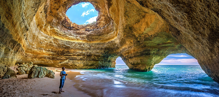 Person standing in the Benagil Cave near Lagoa and Carvoeiro in the Algarve, Portgal