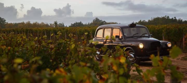 Black cab driving through a vineyard - Wine Cab Tours in Bordeaux