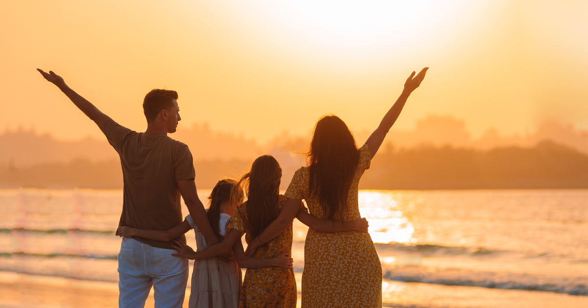 family at sunset on beach