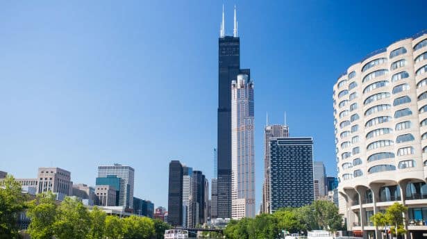 Chicago skyline with the Willis Tower rising prominently against a clear blue sky.