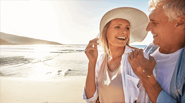 Couple enjoying a peaceful beach walk at sunset during a relaxing coastal holiday