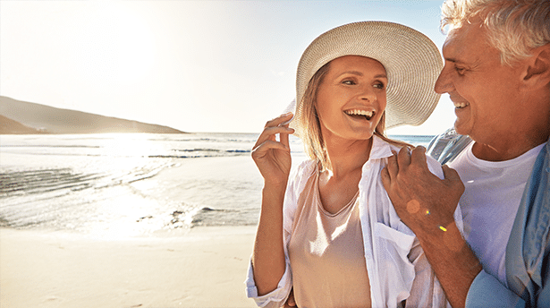 Couple enjoying a peaceful beach walk at sunset during a relaxing coastal holiday