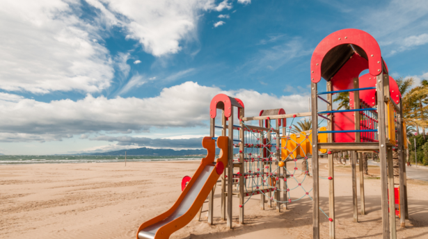 Salou beach playground with slides and climbing frame on sandy seafront overlooking the Mediterranean