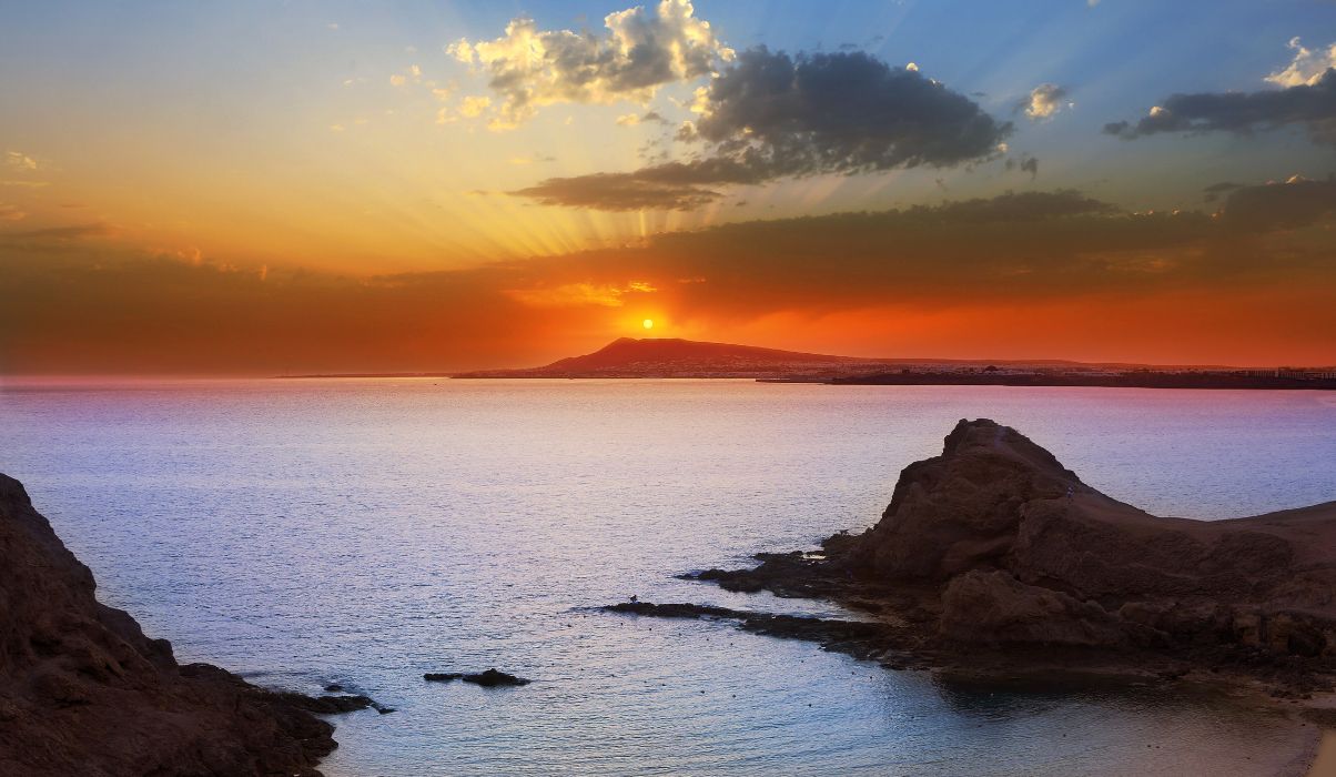 The stunning orange sky in Lanzarote as the sunsets over the ocean.