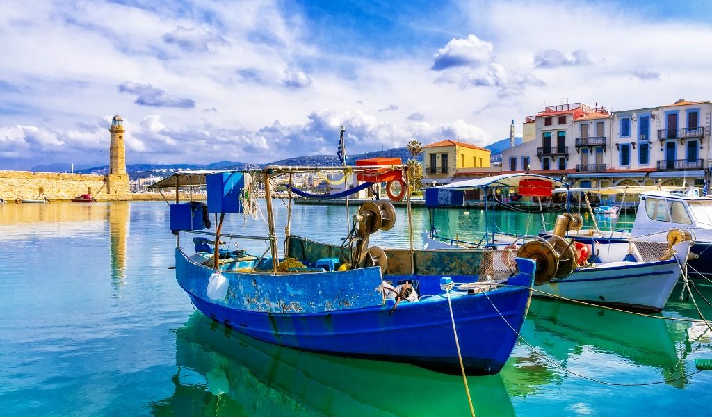 Boats docked surrounded by the vibrant colouful buildings in Rethymnon.