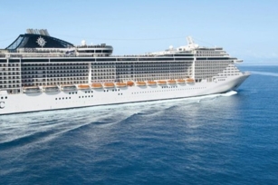 Close up of the side of the cruise ship MSC Fantasia featuring the clear skies and waters.