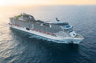 aerial view of the MSC Grandiosa cruise ship featuring the sun shining against the blue watera