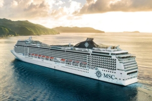 image of the MSC Magnifica cruise ship featuring the calm sea with the background of cliffs