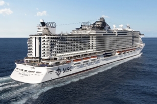 Image of the MSC Seaside from the back of the ship featuring the sunny blue skies while the ship glides through the deep blue waters