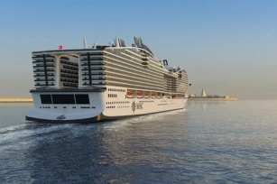 image from behind the MSC World Asia cruise ship on a clear sunny day